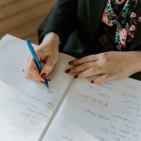 female taking social media strategy notes from client